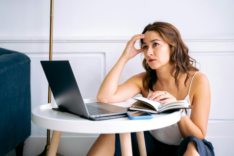 Self care for entrepreners - woman at laptop staring into space